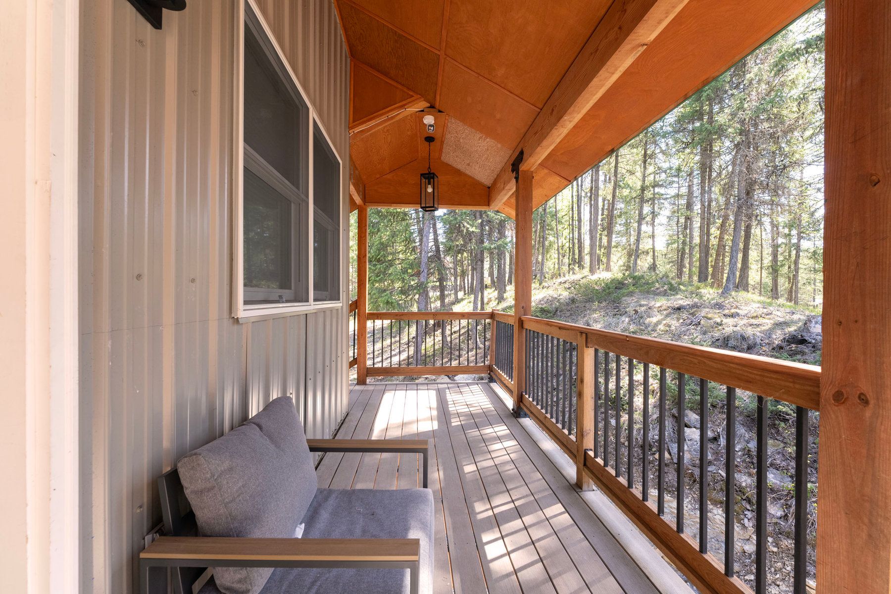Covered porch of a private cabin among the pines at North Star Ranch