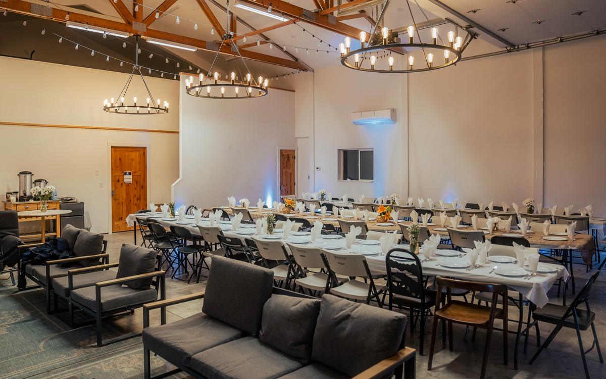 Long dinner tables set in the Great Room at North Star Ranch